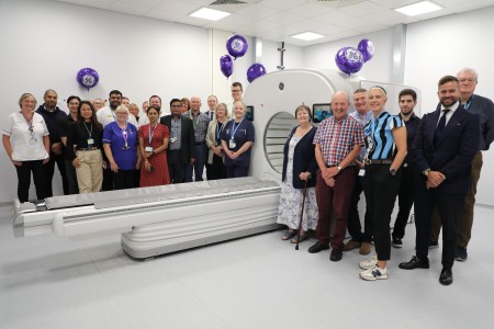 An image showing a variety of colleagues in the Royal Liverpool Hospital's nuclear medicine department standing next to the new Starguide scanner. The people in the image are happy and there are balloons to celebrate the opening of the new equipment