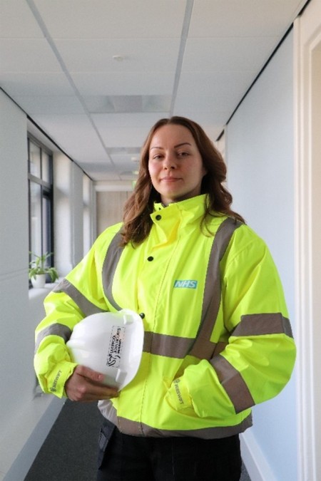 Kasia in the hospital in her uniform and hard hat 